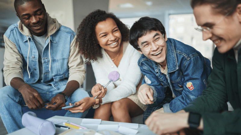 Youth sitting at a table laughing